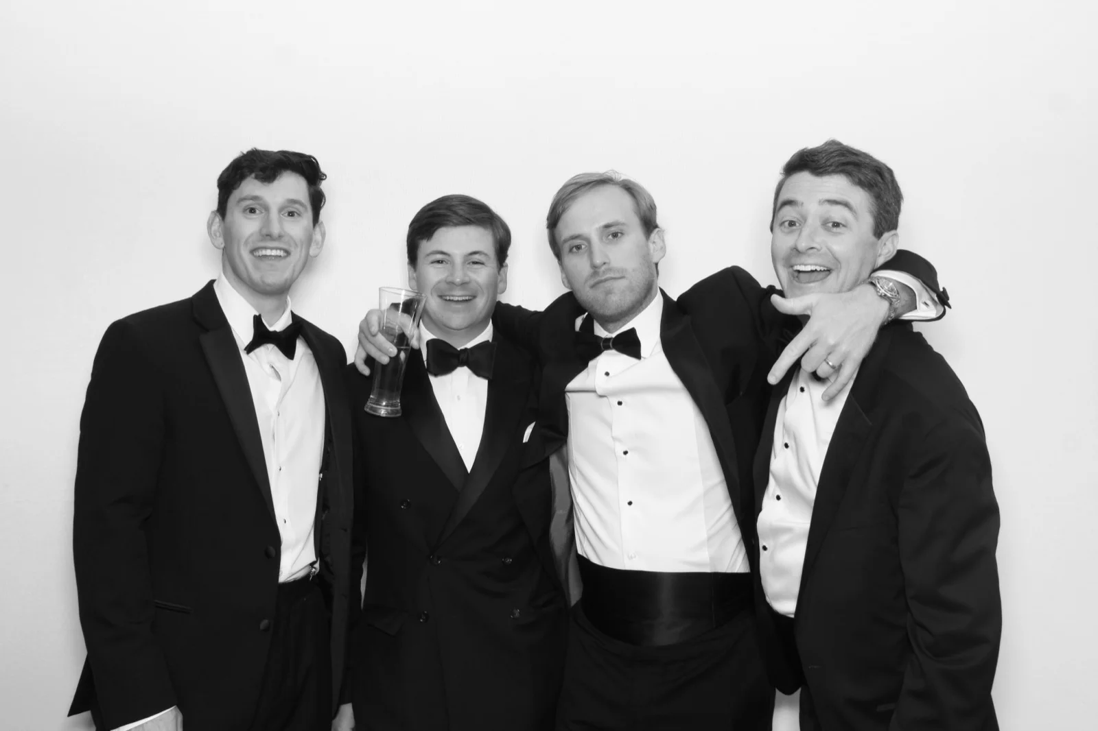NYC glamour photo booth black and white group photo of men in tuxedos at a black-tie event