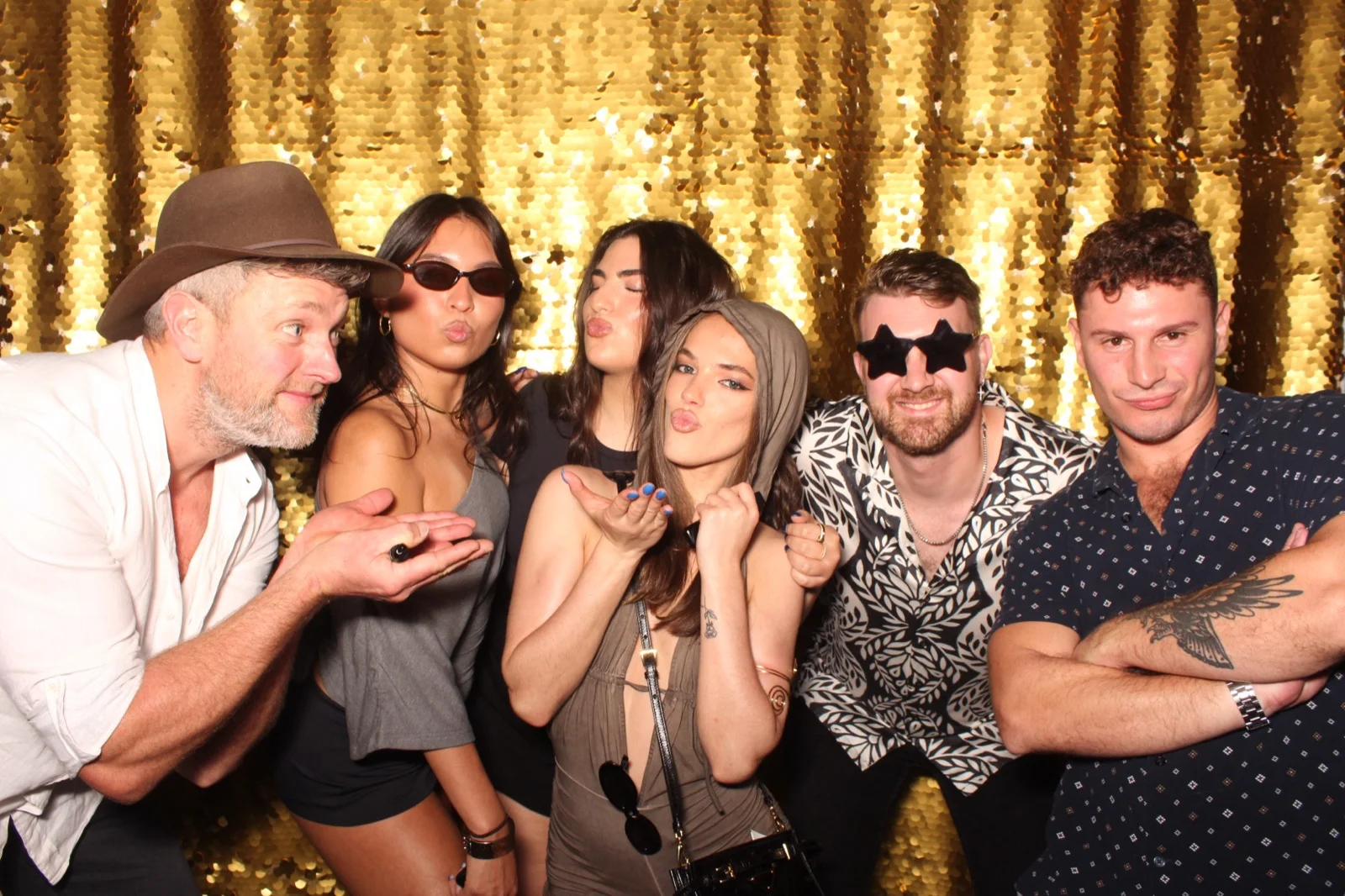 NYC photo booth rental group photo on gold sequin shimmer backdrop at a private party